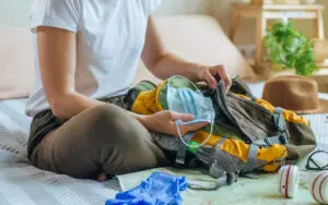 Woman packing backpack.